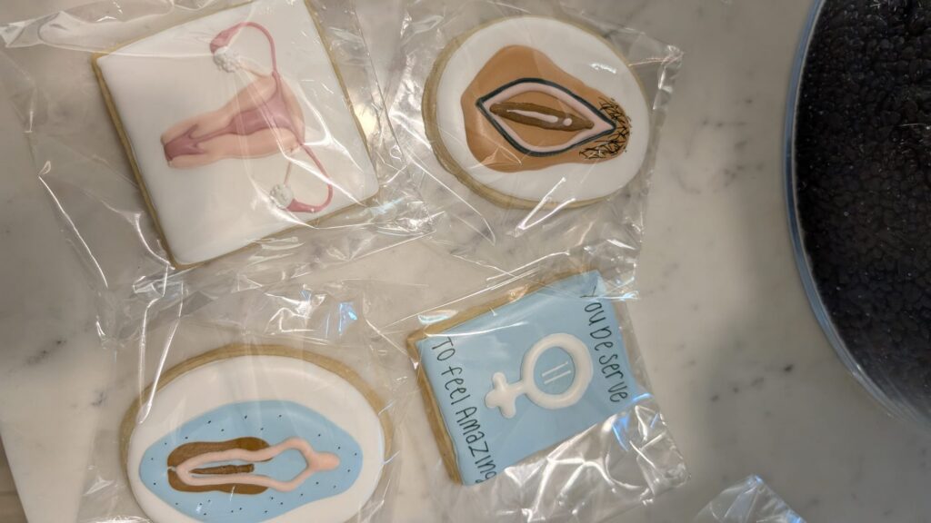 Cookies decorated with gender symbol designs at a Pacific Plastic Surgery Group event
